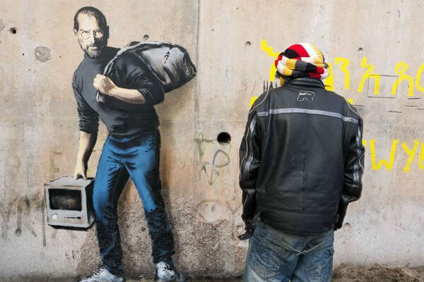 Banksy highlights the refugee crisis through Steve Jobs street art in Calais