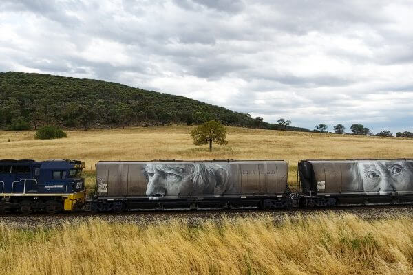 Guido Van Helten, Street Art Freight Carriages, Manildra, Australia 2016. Photo Credit @followthewanderers @selinamiles @bydrewmac @guidovanhelten