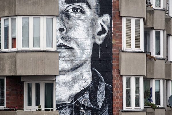 The memorial wall portrait by Nils Westergard shows the Auschwitz detainee Walter Degen in his concentration camp prisoner’s uniform and with his prisoner number 20285, as well as the pink triangle on his left breast. Berlin 2019. Photo Credit Nika Kramer / Urban Nation