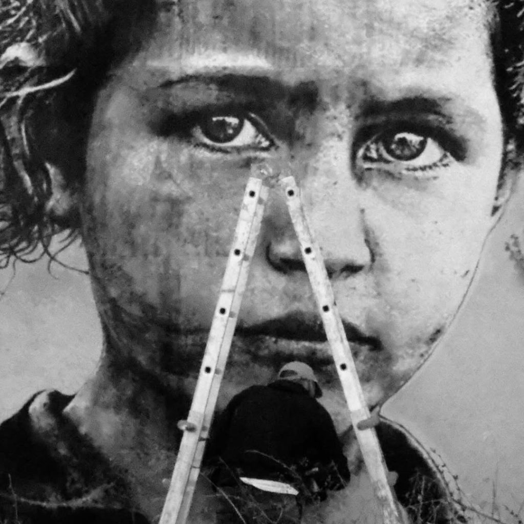 Detail of Ricardo Romero Sebastião Salgado mural depicting rural girl portrait